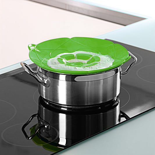 Green silicone lid fits on stainless steel saucepan for easy boiling control.