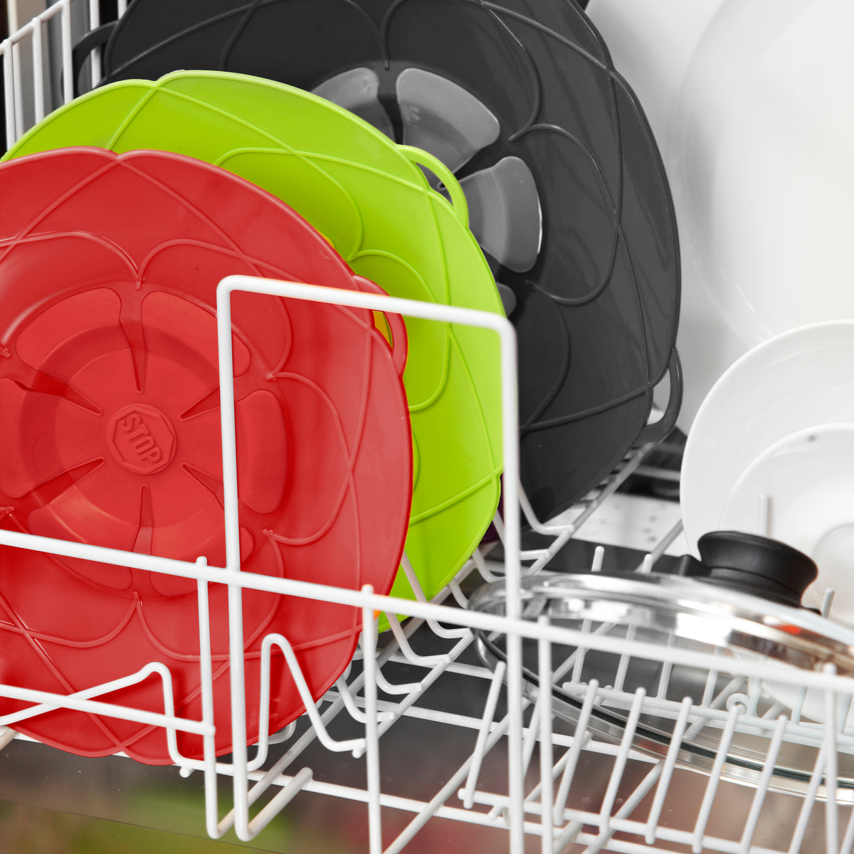 Close-up of colorful, dishwashing-safe lids in a dishwasher rack.