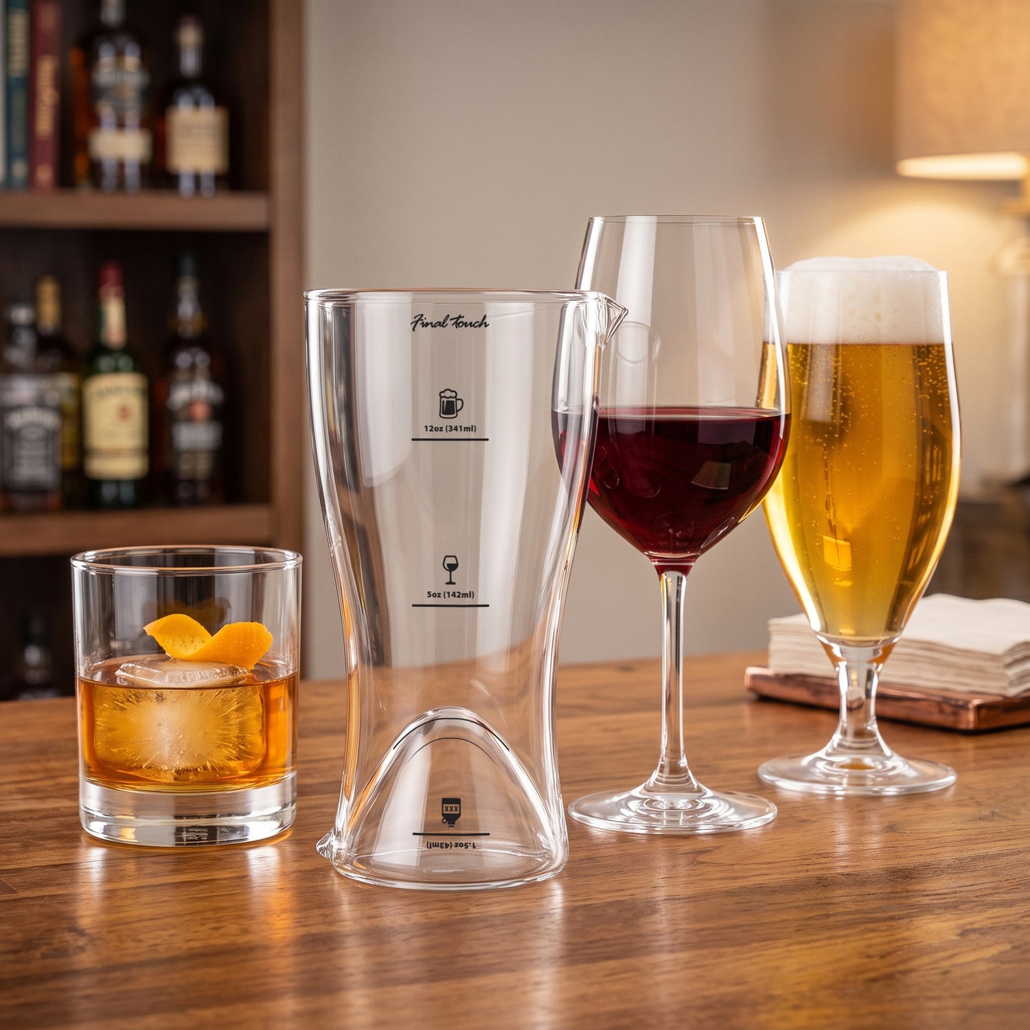 Final Touch multi-measure drink glass on a bar top beside filled whiskey, wine, and beer glasses.