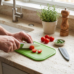 Final Touch compact 5.5 x 7.5 inch non-slip plastic cutting board set with white ceramic paring knife, soft-grip handle, and matching grey blade guard.