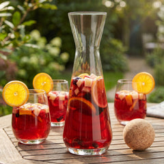 Final Touch glass sangria carafe with cork ball stopper next to matching stemless glasses filled with red wine sangria.