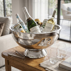 Final Touch Double-Wall Beverage Bin in polished stainless steel filled with ice, champagne, and white wine on a wooden table alongside stemless Red Wine Glasses and ice tongs.